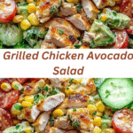 A colorful grilled chicken avocado salad bowl featuring grilled chicken slices, diced avocado, sweet corn, cherry tomatoes, and cucumbers over a bed of romaine lettuce with creamy dressing.